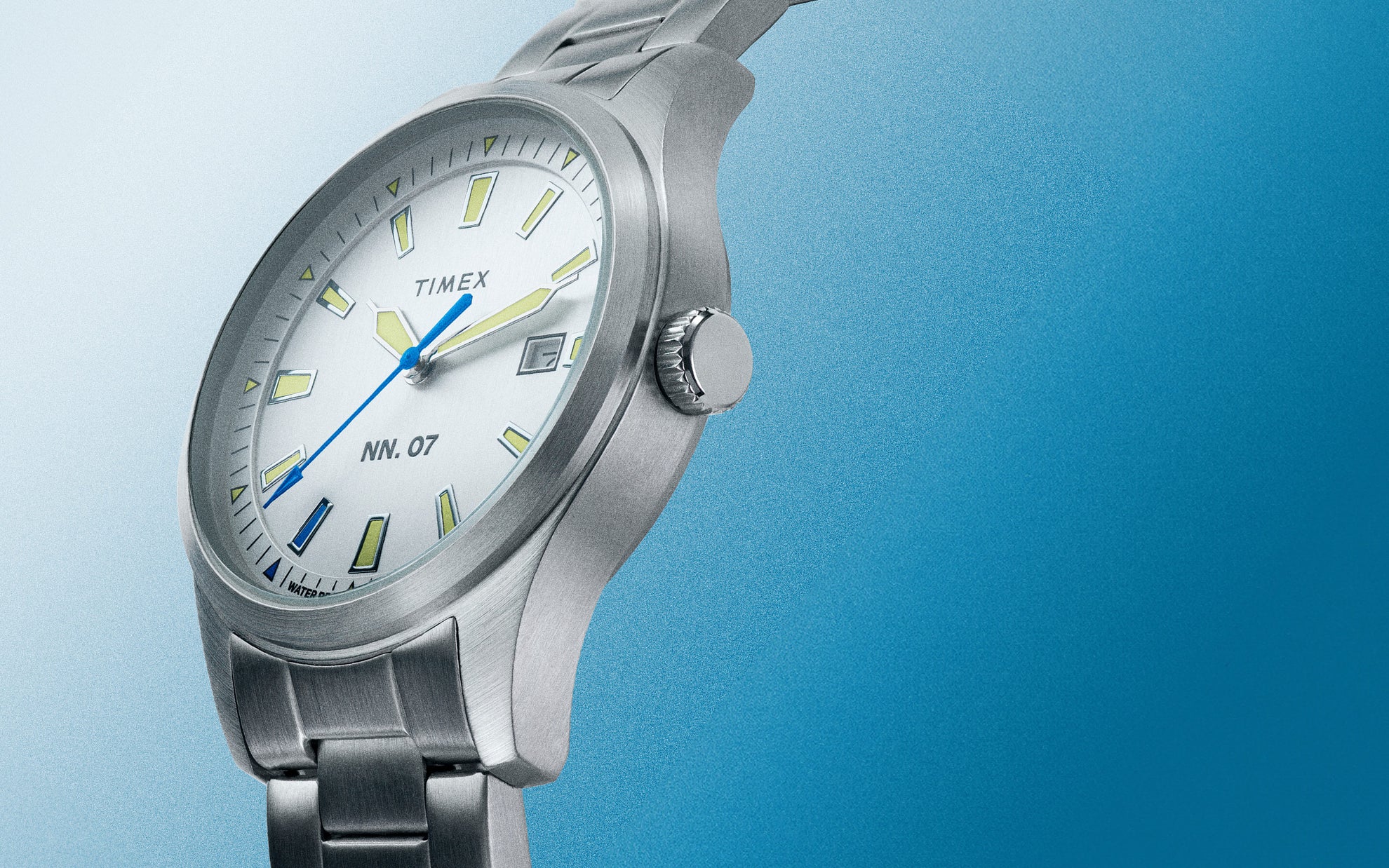 Side profile imagery of NN.07 with a stainless steel strap on a blue background