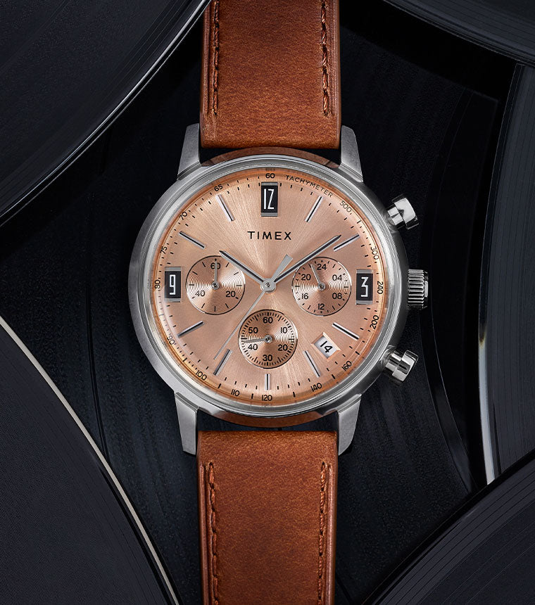 Full vertical view of the Marlin Chronograph Automatic sitting amongst vinyl records in the background