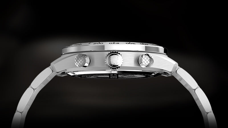 Side profile of the Timex Waterbury Chronograph showcasing the brushed stainless steel case, textured pushers, and signed crown. The slim case design and integrated bracelet links are visible, emphasizing the watch’s refined craftsmanship and sporty silhouette.