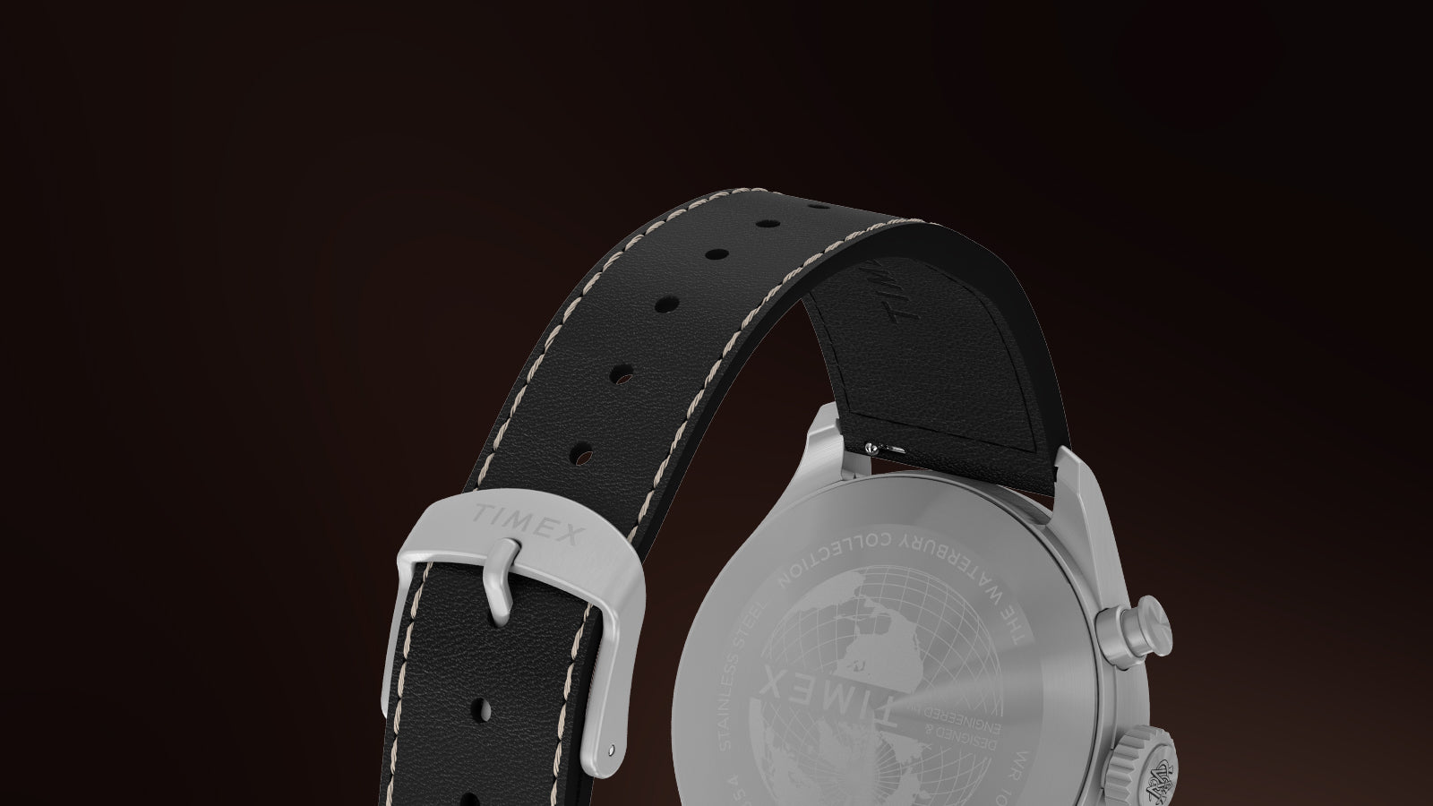 Back view of the Timex Waterbury Ace Chronograph showing the engraved stainless-steel caseback with globe design and black leather strap with white stitching and Timex-branded buckle.