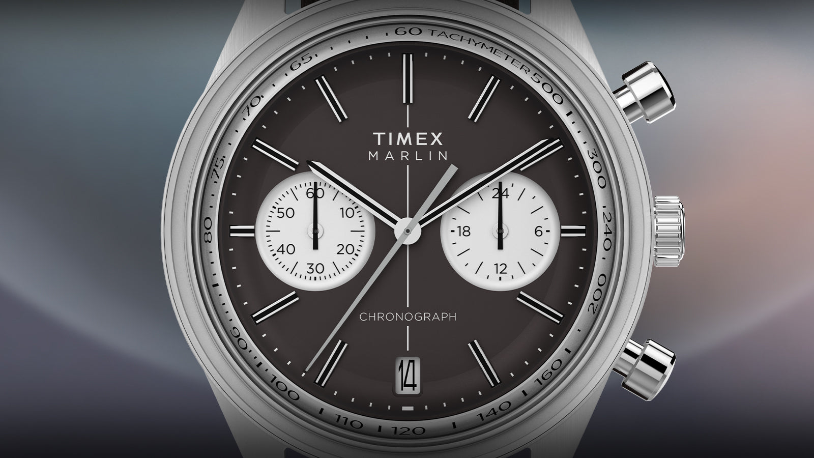 Detailed front-facing render of the Timex Marlin® Jet Quartz Chronograph. Features include a matte brown dial, crisp white chronograph sub-dials, date window at 6, and silver-tone tachymeter bezel with baton hour markers.