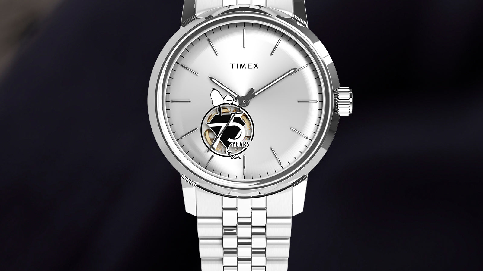 Render of the Timex x Peanuts® Marlin® Automatic watch, showing a polished stainless steel case, silver-tone dial, minimalist indices, Snoopy and 75 Years logo at 6 o’clock, and stainless steel bracelet.