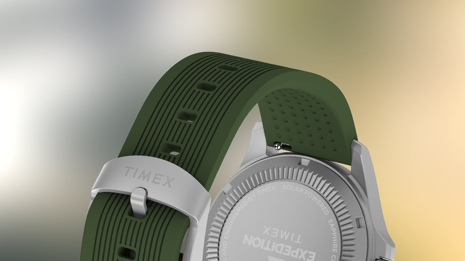 Back view of the durable green strap with textured design and silver buckle engraved with “TIMEX.”