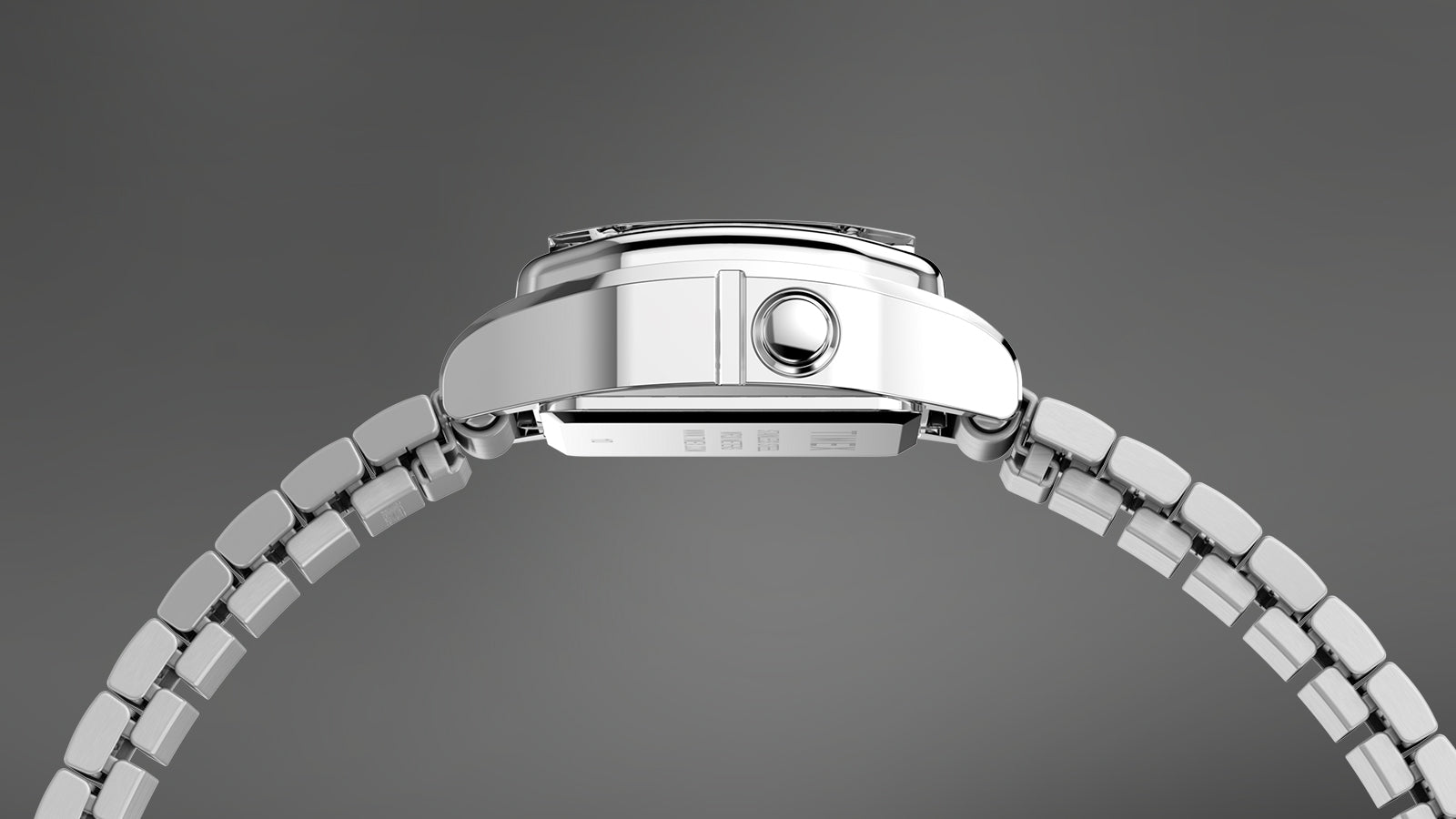 Side profile of the Teeny Tiny Timex digital watch showing its slim stainless-steel case, polished bezel, and compact crown design, emphasizing the watch’s lightweight and refined vintage construction.