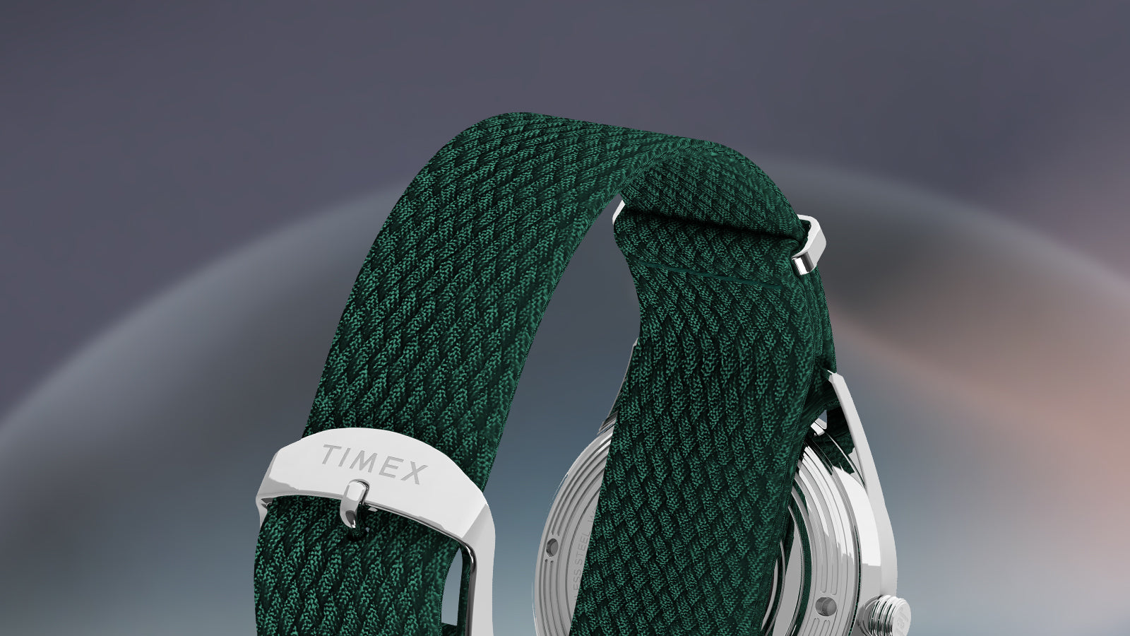 Back view of the Timex Marlin® Jet Automatic watch strap, highlighting the textured green woven material and stainless-steel buckle engraved with “TIMEX.”