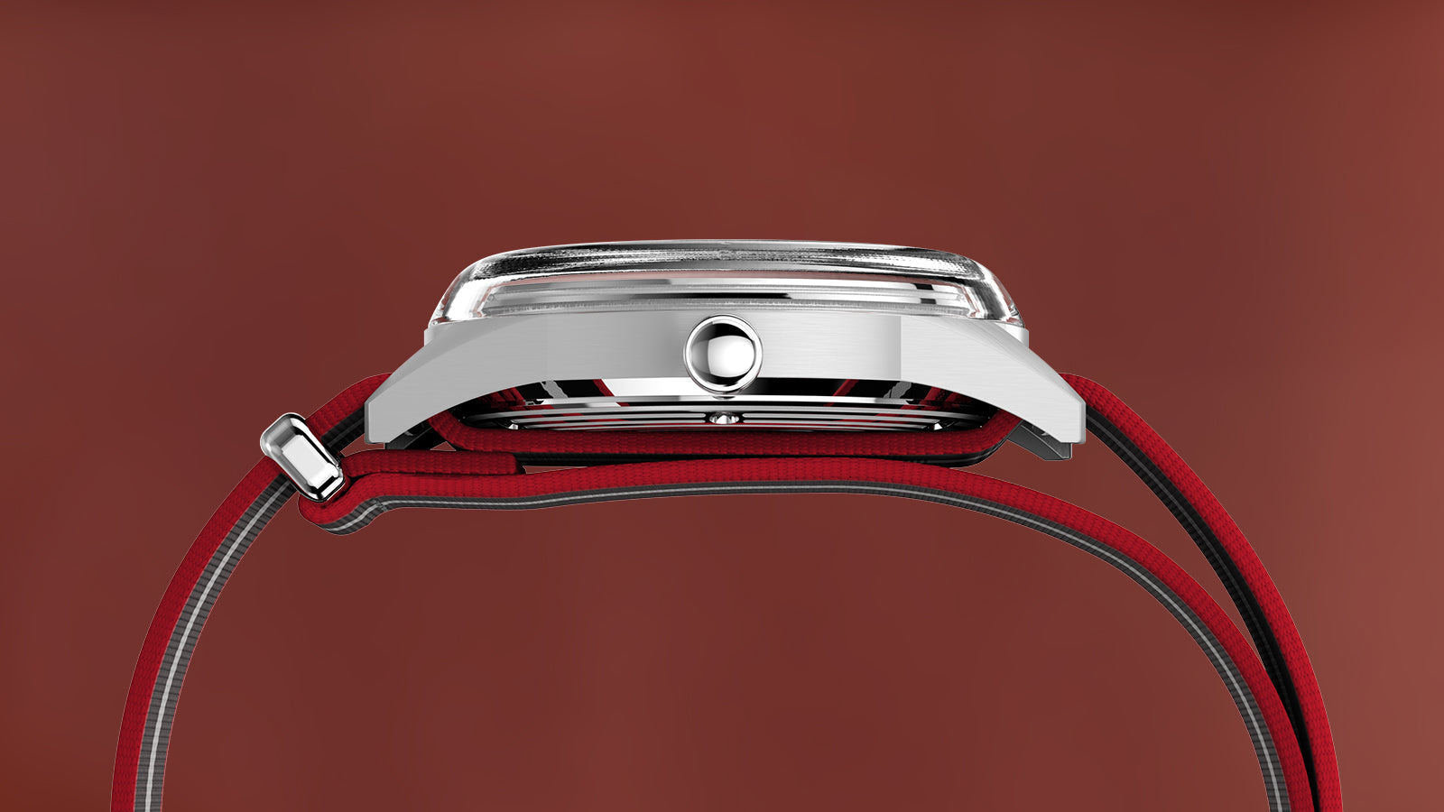 Side profile of the Timex Marlin® Jet Quartz watch with domed crystal and stainless-steel case, paired with a red and black striped fabric strap.