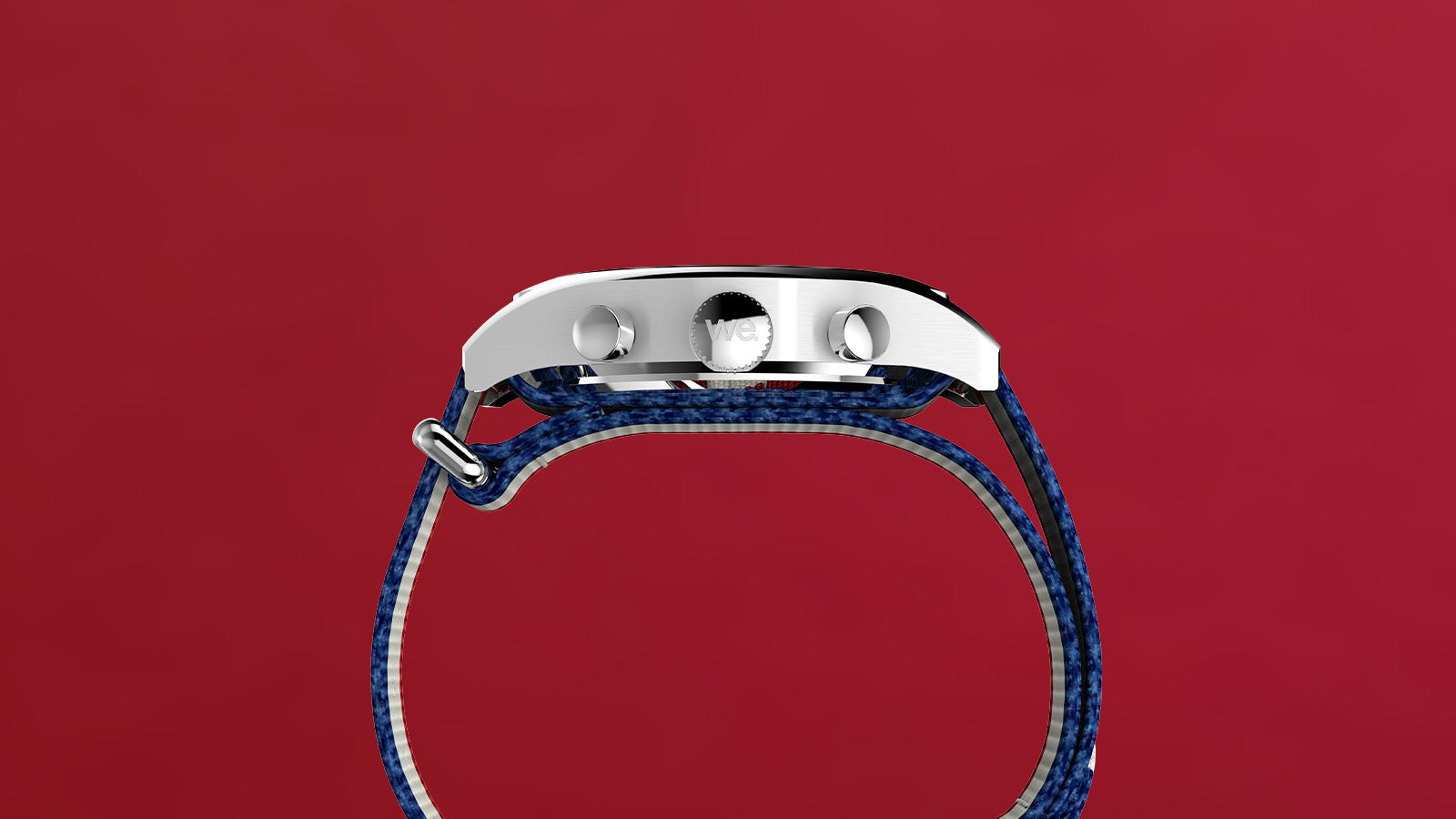 Side view of the Timex Weekender New England Chronograph watch, highlighting the stainless steel case, crown, and pushers with blue strap against a red background.