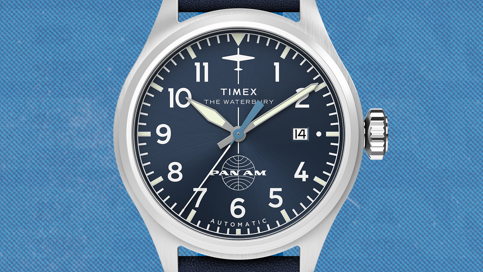 Front view of the Timex x Pan Am® Waterbury Ace automatic watch featuring navy blue dial, luminous sword-style hands, date display, and Pan Am globe logo above 6 o’clock.