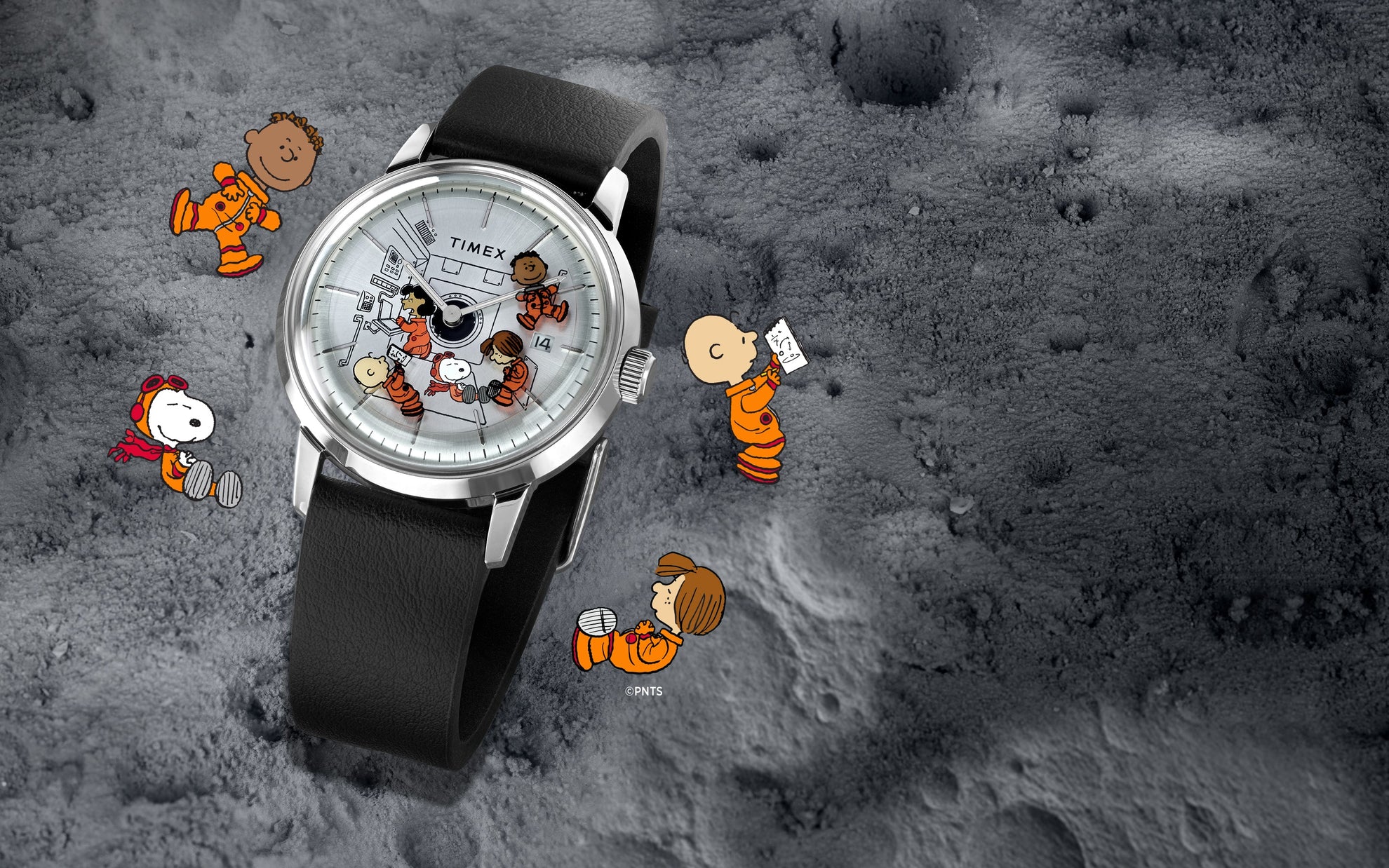 A Timex x Peanuts® Marlin® Automatic watch placed on a textured moon-like surface. The watch dial features Snoopy, Charlie Brown, Lucy, Franklin, and Peppermint Patty in orange space suits floating inside a space capsule. Additional Peanuts characters float around the watch on the lunar surface background.