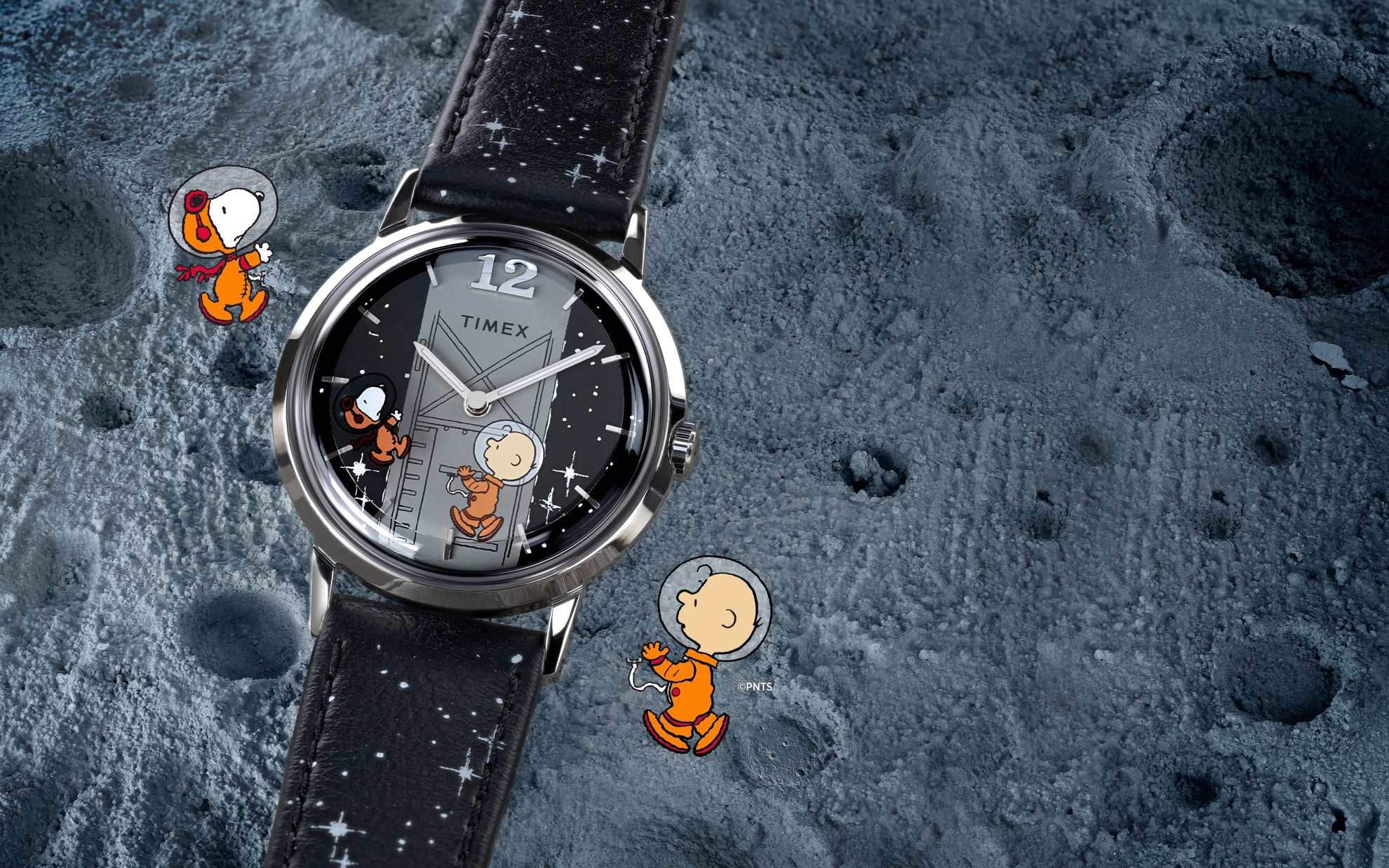A Timex x Peanuts® Marlin® Hand-Wound watch displayed on a textured moon surface background. The black dial shows Charlie Brown climbing a space module ladder and Snoopy in a space helmet floating beside him. The watch has a black leather strap decorated with white stars.