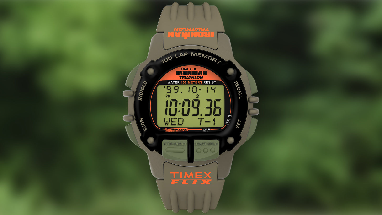 A detailed studio image of the TIMEX® IRONMAN® Flix x Huckberry watch. The screen shows bold black digits with an orange TIMEX FLIX logo on the strap. Features include a 100-lap memory, stopwatch, and water resistance to 100 meters.