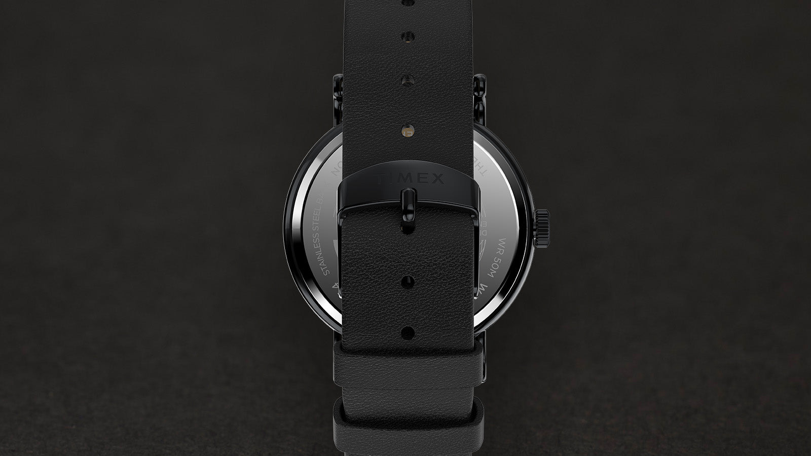 Back view of the Timex Weekender Day of the Dead watch showing the black leather strap, buckle engraved with the Timex logo, and stainless steel caseback.