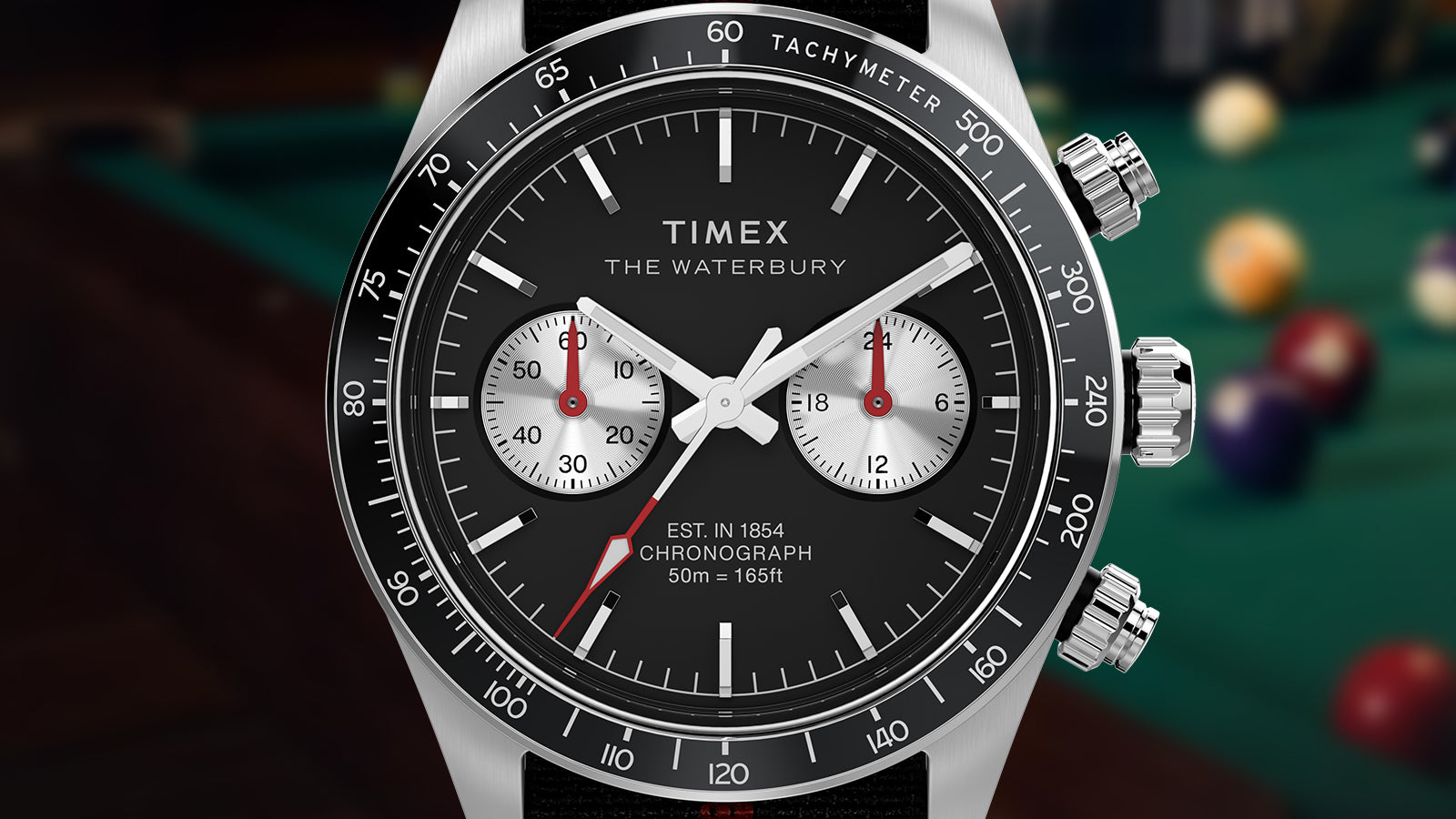 Macro view of the Timex Waterbury Heritage Chronograph dial, highlighting chronograph subdials, luminous hands, and tachymeter markings.