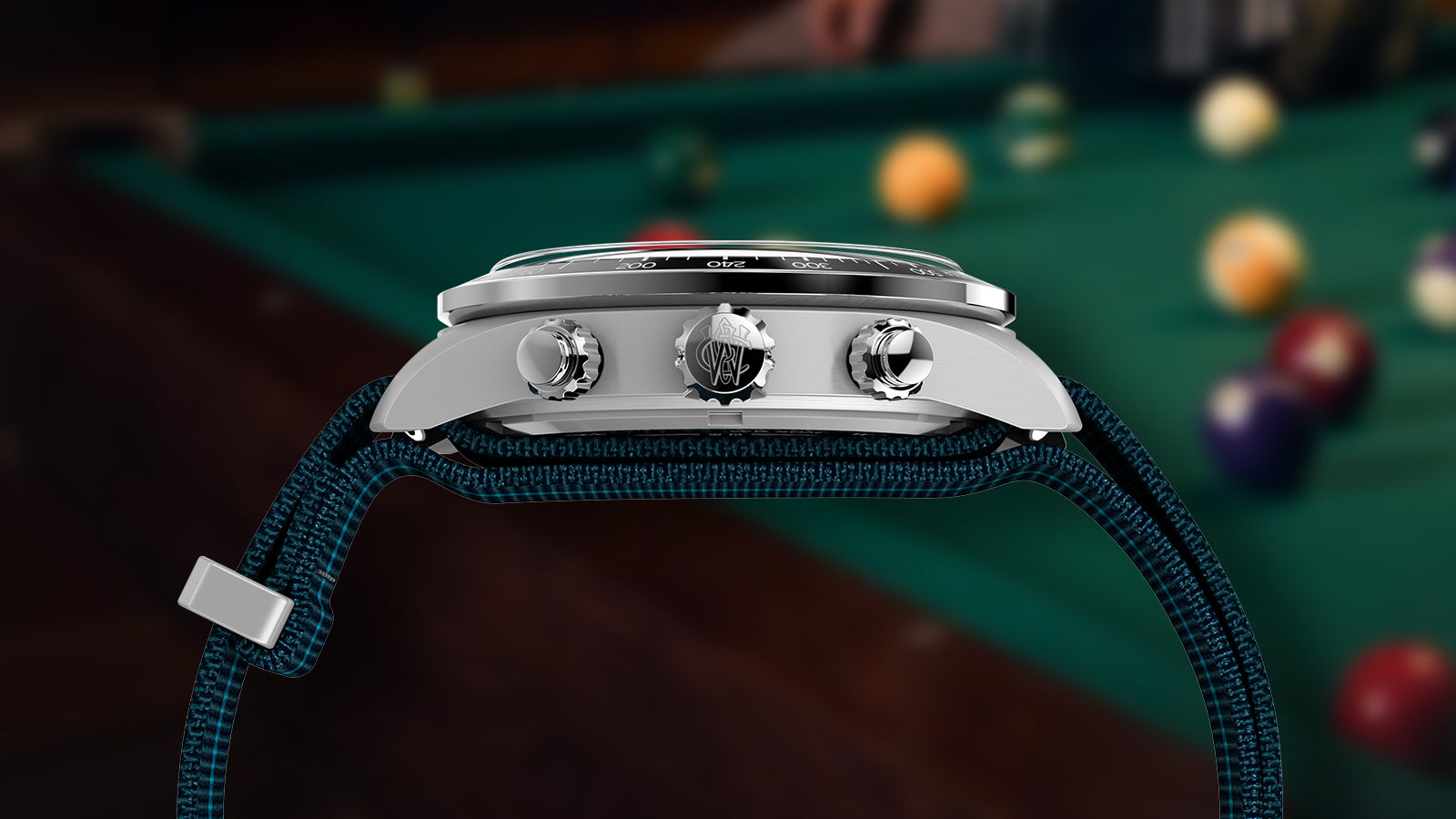 Side profile of the Timex Waterbury Heritage Chronograph watch showing stainless-steel crown and pushers engraved with the Waterbury logo.