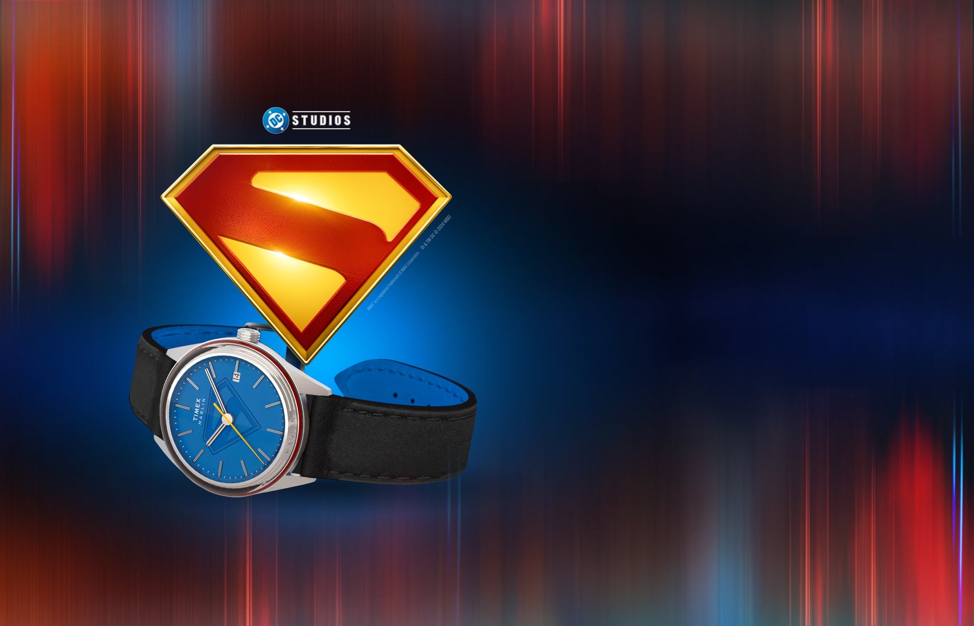 A Timex x Superman Marlin® Jet Automatic watch with a bold blue dial, yellow seconds hand, and Superman’s “S” emblem in the background, with DC Studios branding.