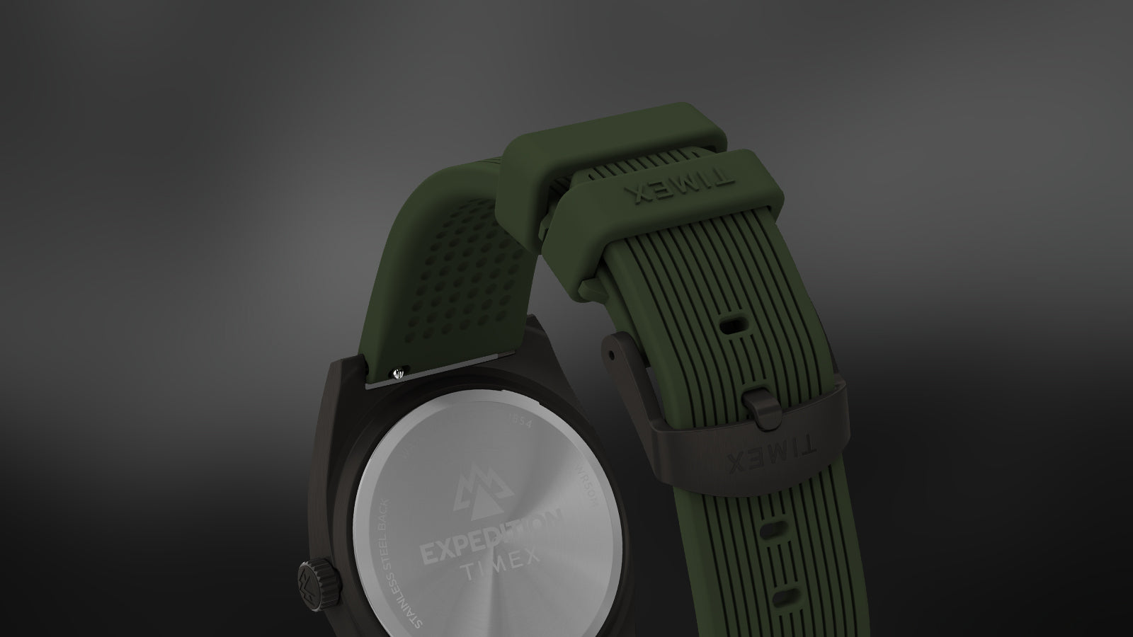 Rear and strap view of the Timex Expedition® Capstone watch, highlighting the engraved stainless-steel back and olive green silicone strap with textured detailing and a Timex-branded buckle.