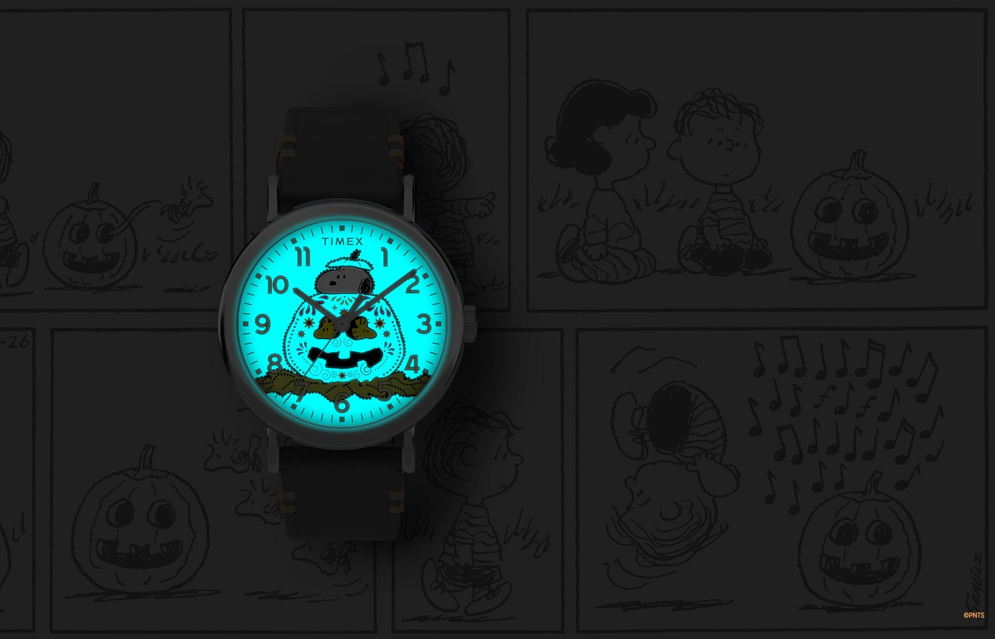 Timex x Peanuts® Weekender Pumpkin Dial watch glowing with INDIGLO® backlight, showing Snoopy and pumpkin design illuminated in bright blue.