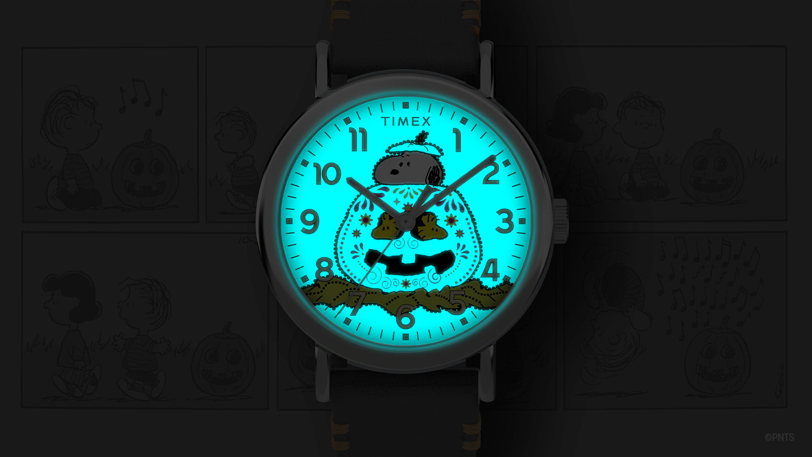 Timex x Peanuts® Weekender Pumpkin Dial watch glowing with INDIGLO® backlight, showing Snoopy and pumpkin design illuminated in bright blue.