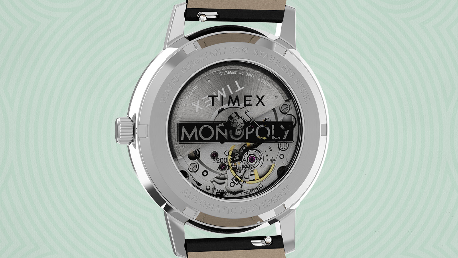 Close-up of the Timex x Monopoly Marlin® Automatic case back, revealing the exposed movement through a transparent exhibition window. The design includes the Monopoly logo printed on the glass with the phrase “Collect $200 as you pass GO,” showcasing the automatic mechanism inside.