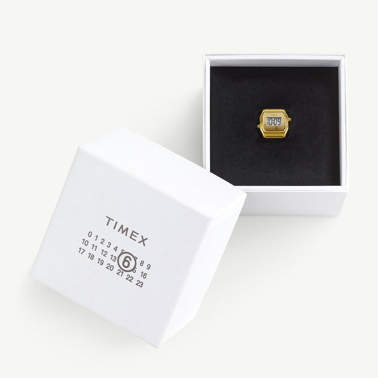 Timex x MM6 Maison Margiela T80 ring watch presented in an open white box with black velvet interior. The packaging features the MM6 calendar logo and Timex branding, emphasizing the collaboration’s sleek, luxury presentation.