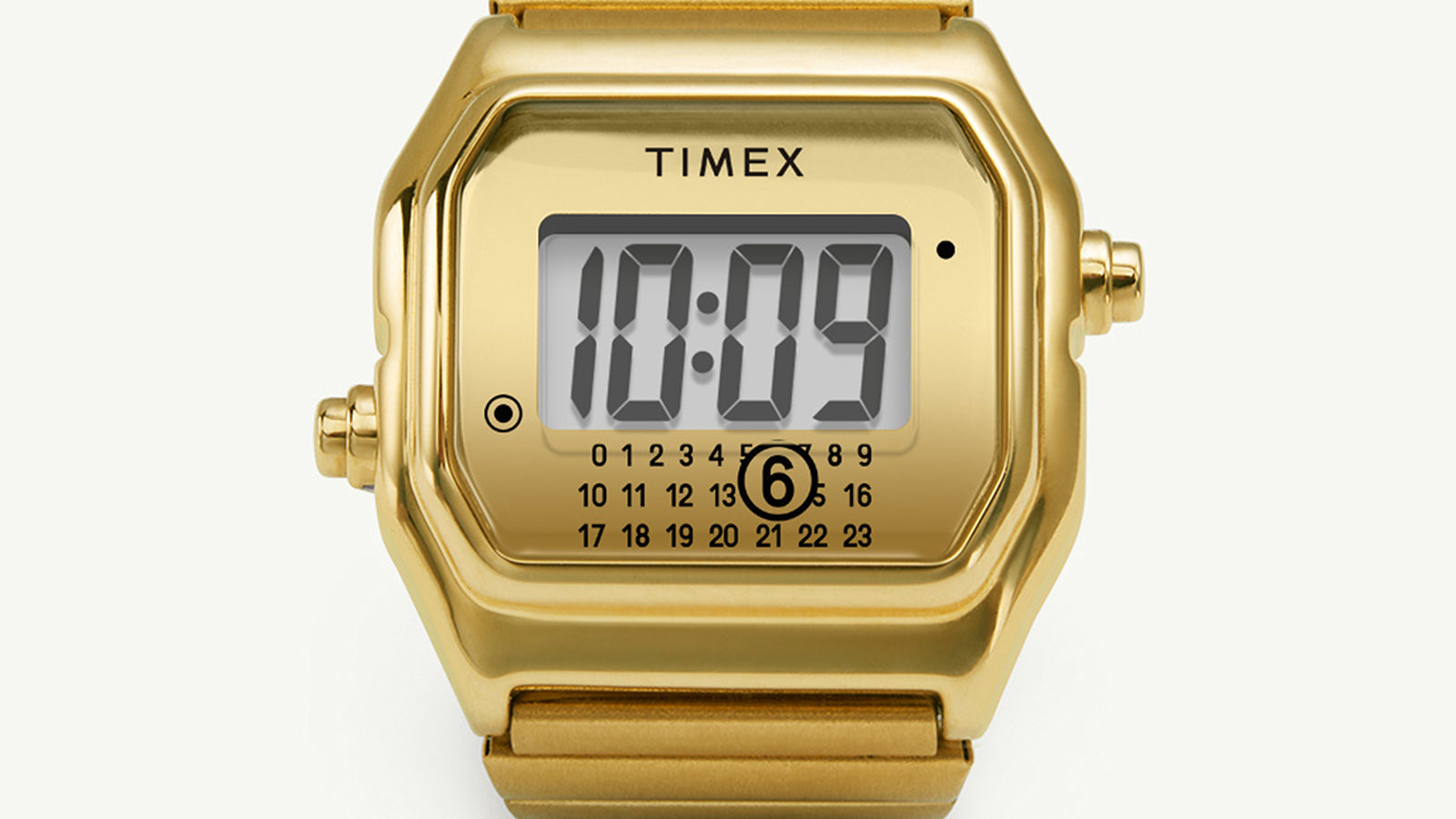 Lifestyle image showing the Timex x MM6 Maison Margiela T80 ring worn on a person’s hand with a beige textured outfit, highlighting the fusion of functional timekeeping and high-fashion design.