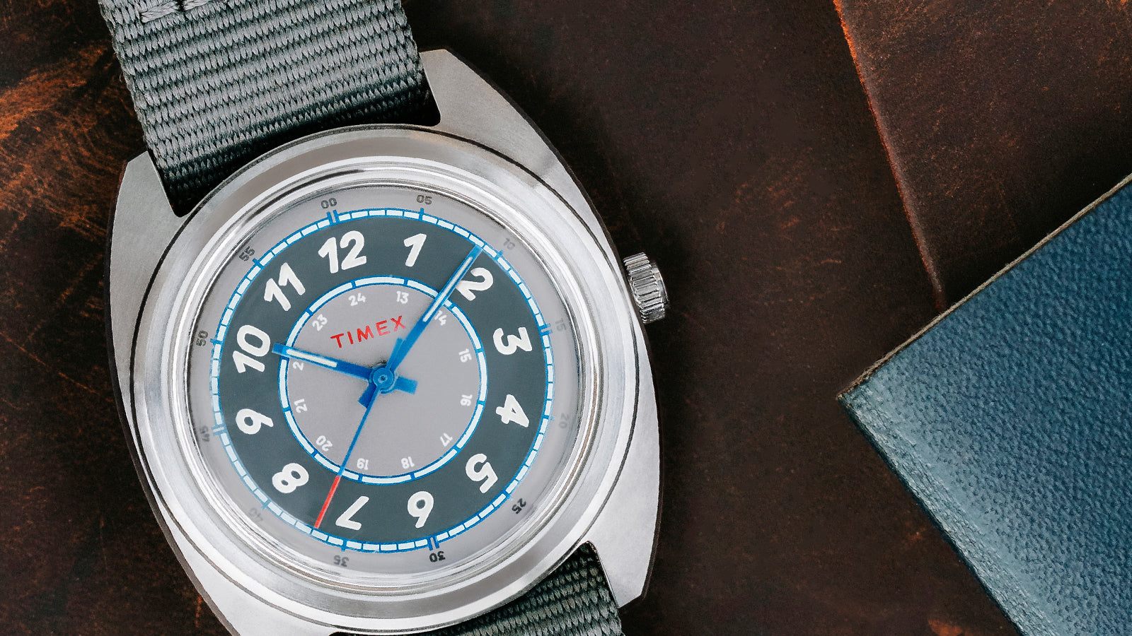 A bright close-up of the Timex x Worn & Wound Storm resting on coiled rope, displaying the brushed stainless-steel case and blue seconds hand.