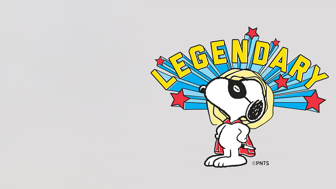 Illustration of Snoopy as a superhero with the word “Legendary” in bold letters above, surrounded by stars and comic-style rays, celebrating the playful spirit of the Timex x Peanuts collection.