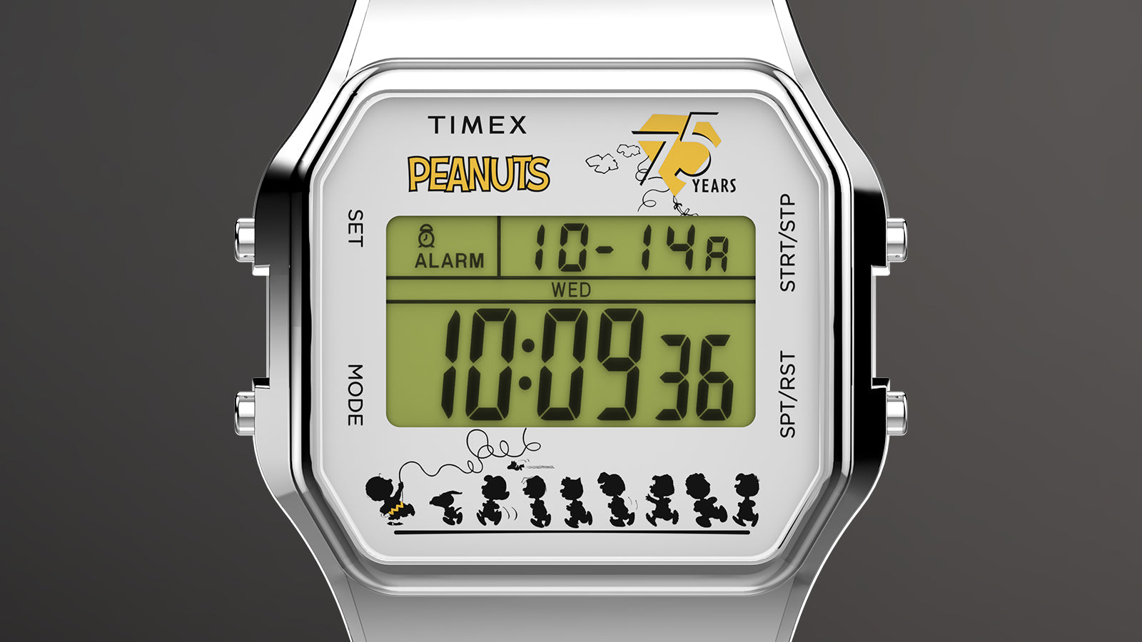 Close-up of the Timex x Peanuts® T80 75th Anniversary Edition digital watch display. The screen shows the Peanuts logo, 75 Years anniversary emblem, and silhouettes of the Peanuts gang in motion beneath the digital time display.