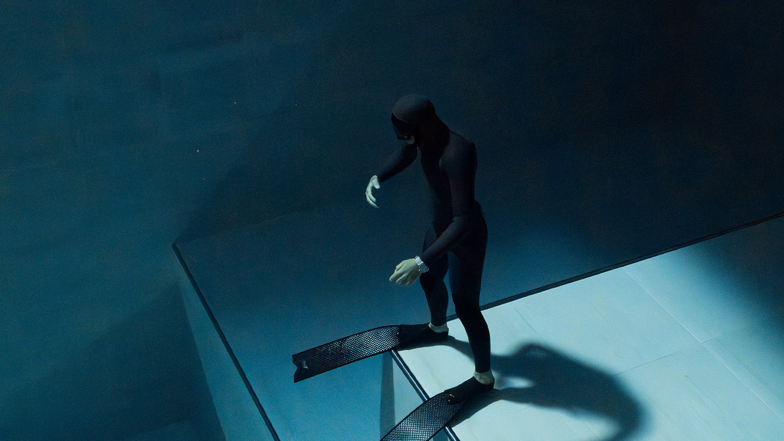 Underwater diver captured in motion wearing the Timex Deepwater Reef 200 GMT, showcasing its durability and precision at depth.