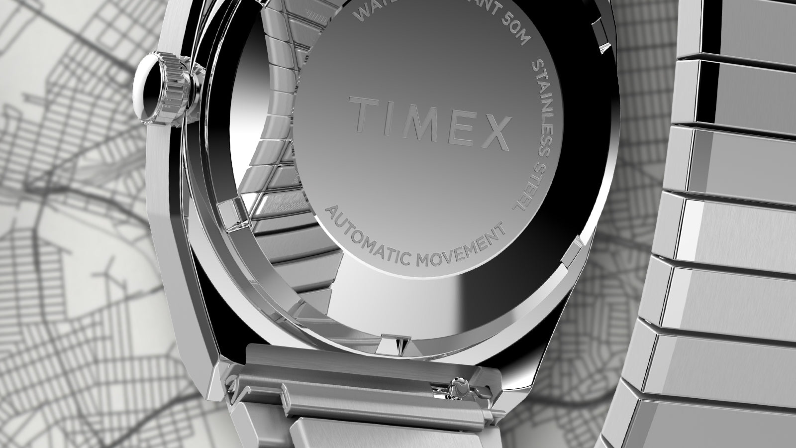 Close-up of the caseback of the Timex® Automatic 1983 E Line Reissue watch showing the engraved TIMEX logo, stainless-steel finish, and automatic movement marking.