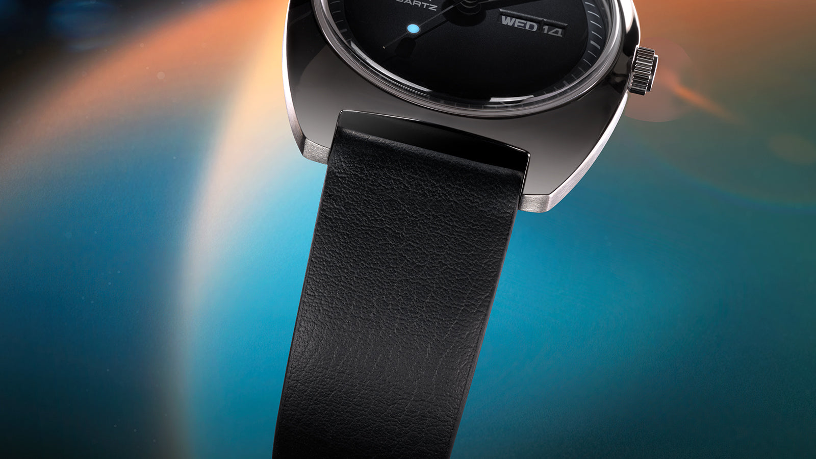 Macro shot of the Q Timex® 1975 Enigma leather strap showing fine grain texture and smooth connection to the polished case.