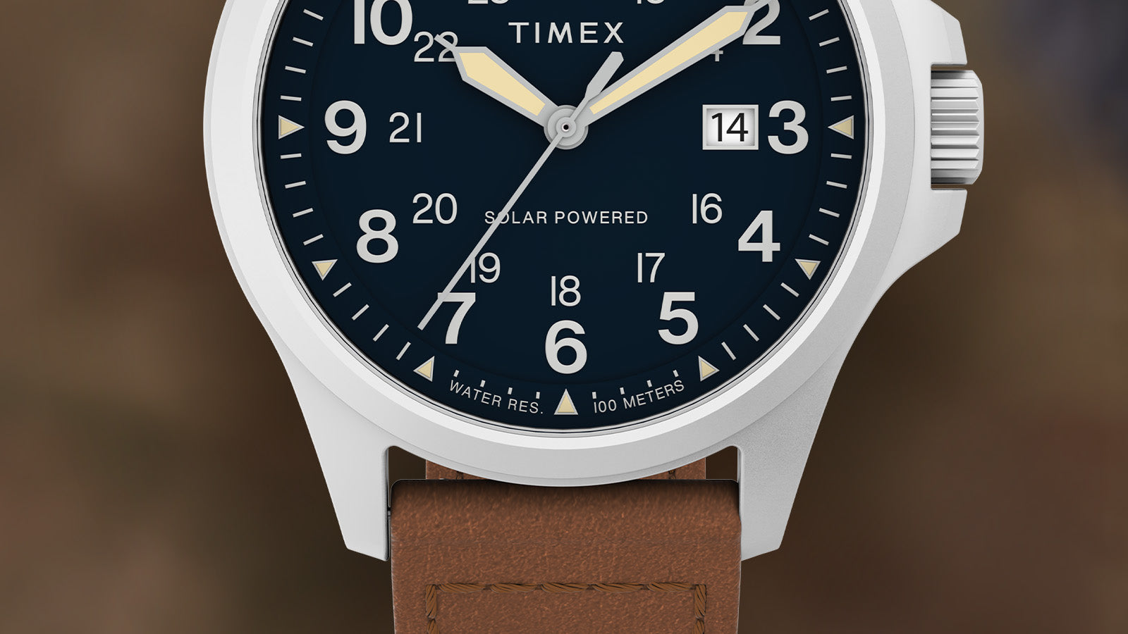 Close-up of the Timex Expedition Field Post Solar watch face, showing bold white numerals, luminous hands, a date window at 3 o’clock, and “Solar Powered” text above 6 o’clock.