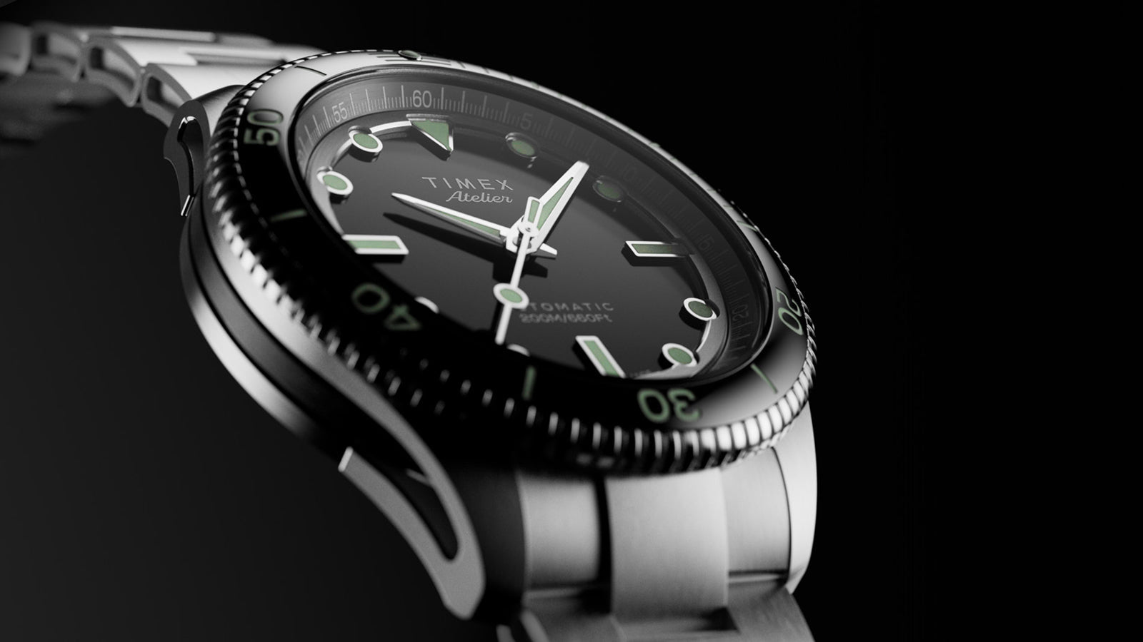 Low-angle close-up of Timex Atelier automatic dive watch highlighting the curved lugs, rotating bezel, and glossy black dial with luminous hands.