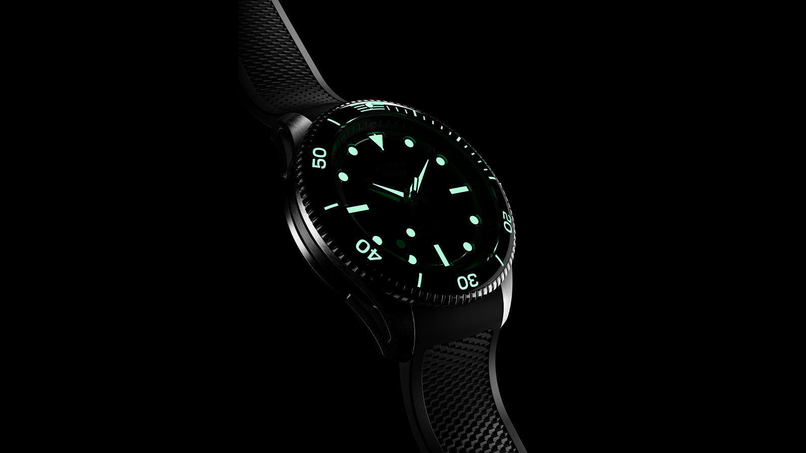 Timex Atelier automatic watch with black dial and glowing luminescent markers, fitted on a textured black rubber strap, displayed against a black background.