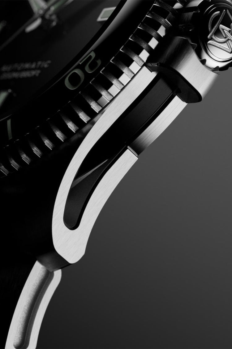 Macro detail of the case side and lug of the Timex Atelier watch, showing brushed and polished stainless steel surfaces.