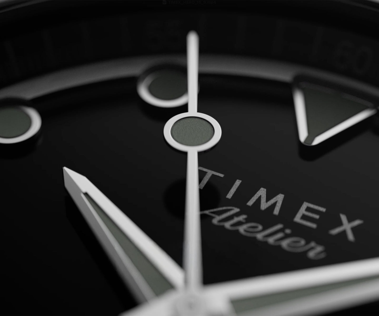Extreme close-up of the Timex Atelier watch dial, showcasing polished silver hands and luminous markers against a glossy black background with the “Timex Atelier” logo.