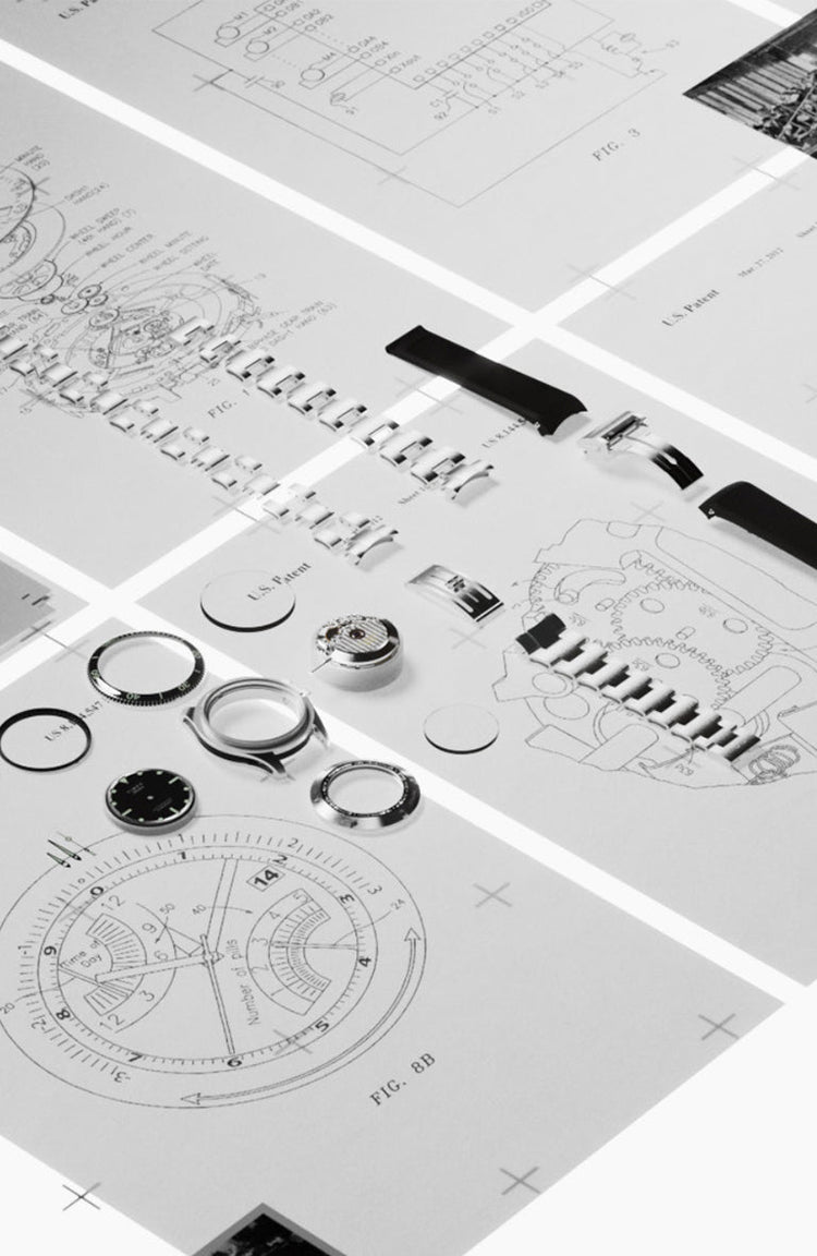 Flat lay of technical watchmaking blueprints and exploded diagrams of components, with Timex Atelier case parts, bezels, and movements displayed on top.