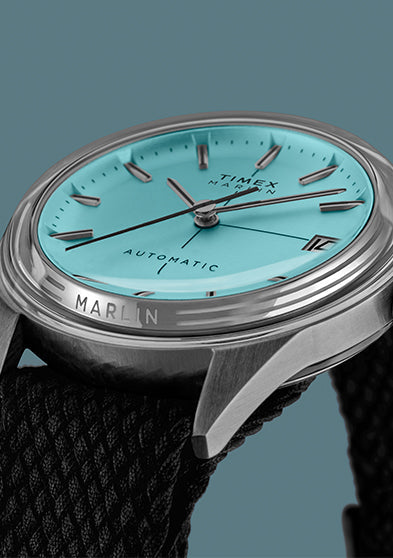 Timex Marlin Jet Automatic showing the polished stainless-steel case, crown, and black fabric strap.