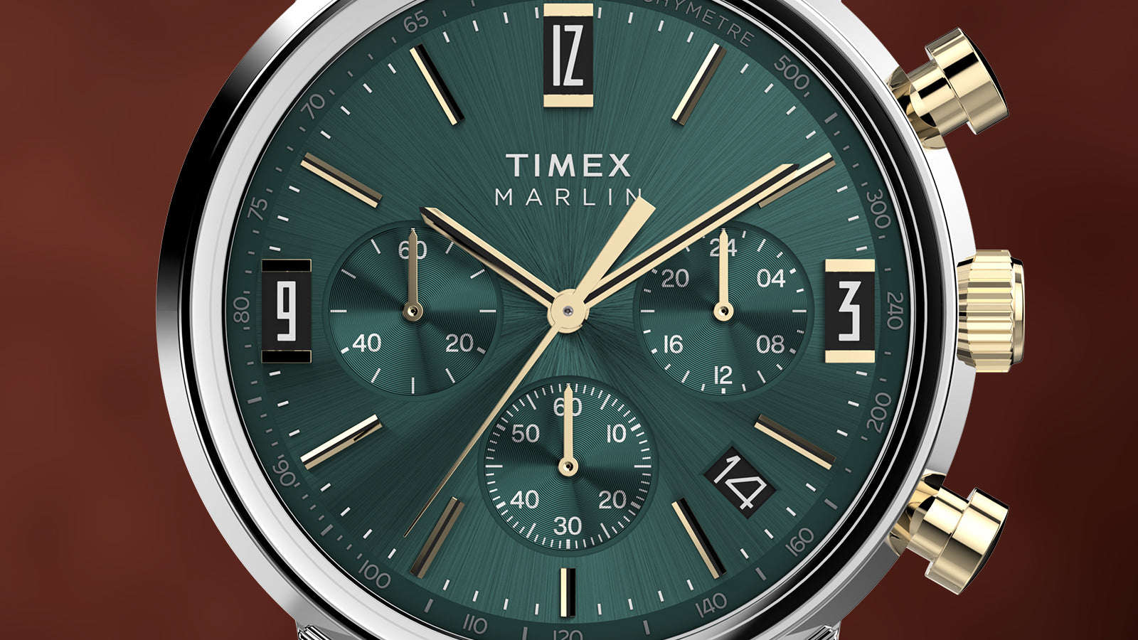 Close-up of Timex Marlin Chronograph Tachymeter green dial with gold-tone details, three subdials, and tachymeter markings.