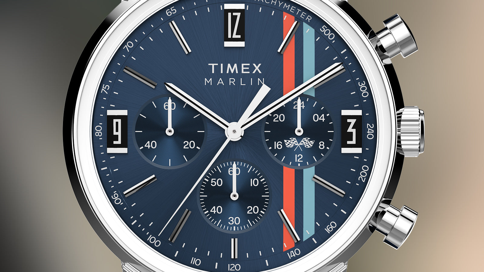 Close-up of Timex Marlin Chronograph Tachymeter face showing blue dial, sub-dials, and orange and light blue racing stripes.
