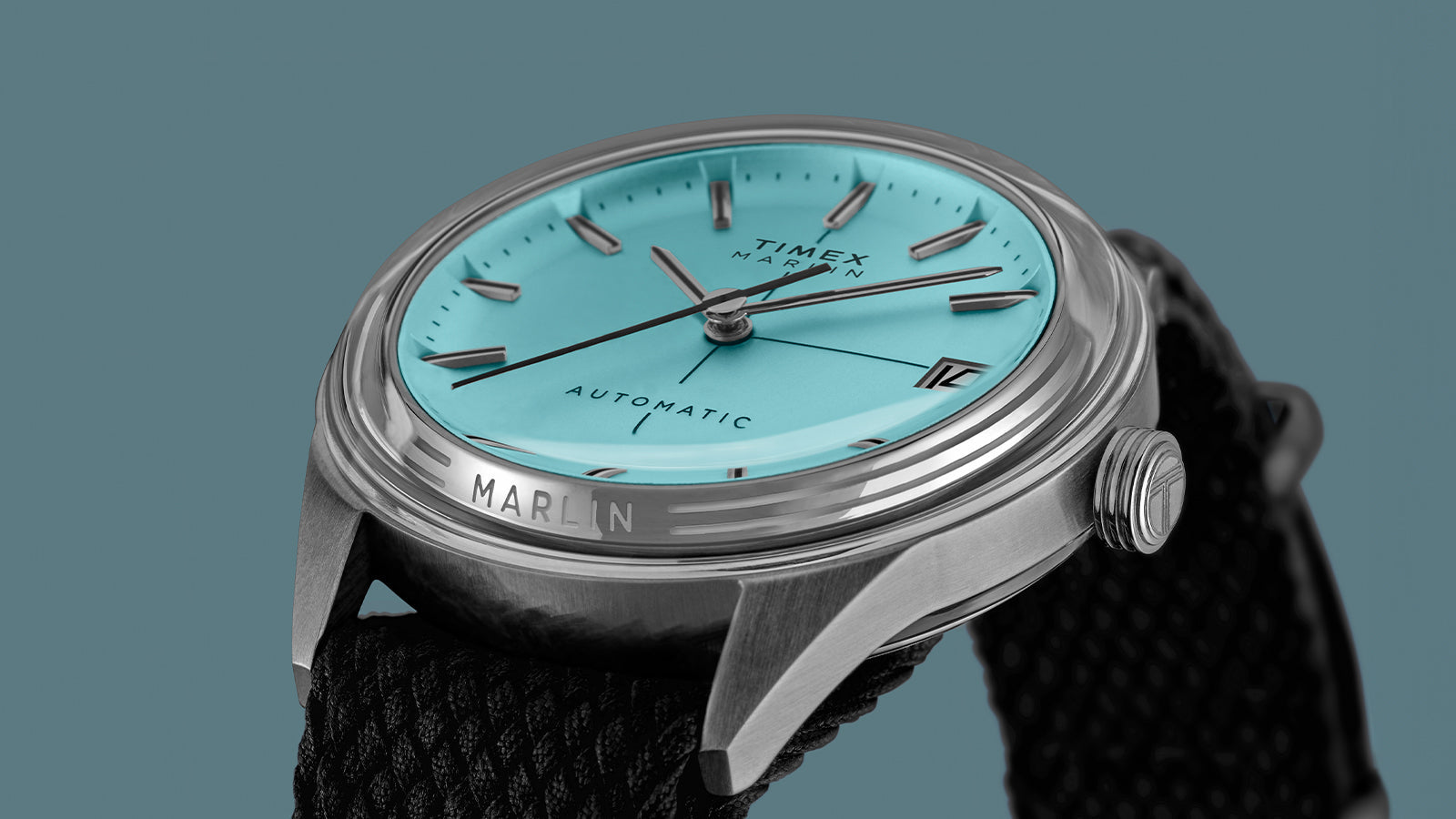 Timex Marlin Jet Automatic showing the polished stainless-steel case, crown, and black fabric strap.