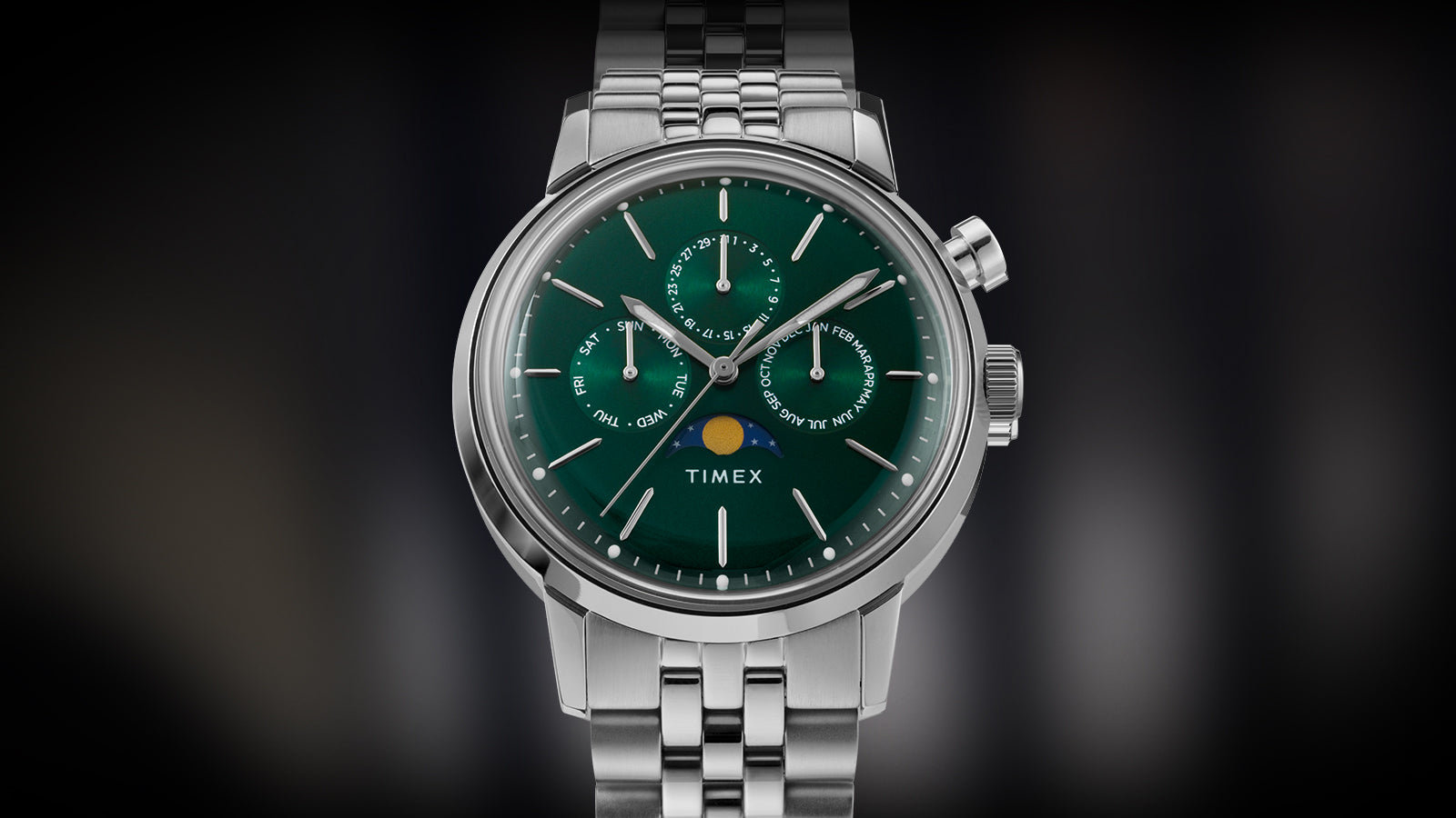 Front view of Timex Marlin Moon Phase Multifunction featuring a green dial with three sub-dials and a moon phase display at the 6 o’clock position.