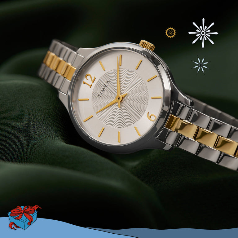 Timex Peyton watch featuring a two-tone stainless steel bracelet with gold accents and a silver dial with gold-tone hands and markers. The dial has a wavy textured center and minimalist design with Arabic numerals at 12 and 6 o’clock.