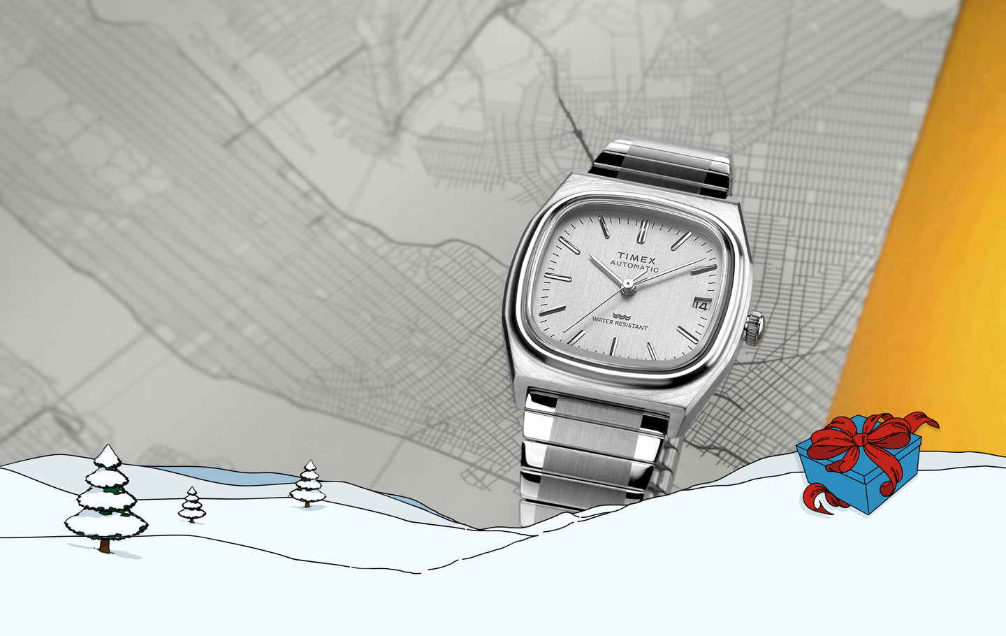 Timex Automatic 1983 E Line Reissue stainless steel watch with a silver dial and bracelet, displayed against a grayscale city map background. The bottom foreground features an illustrated snowy landscape with pine trees and a blue gift box wrapped with a red ribbon, evoking a winter holiday theme.