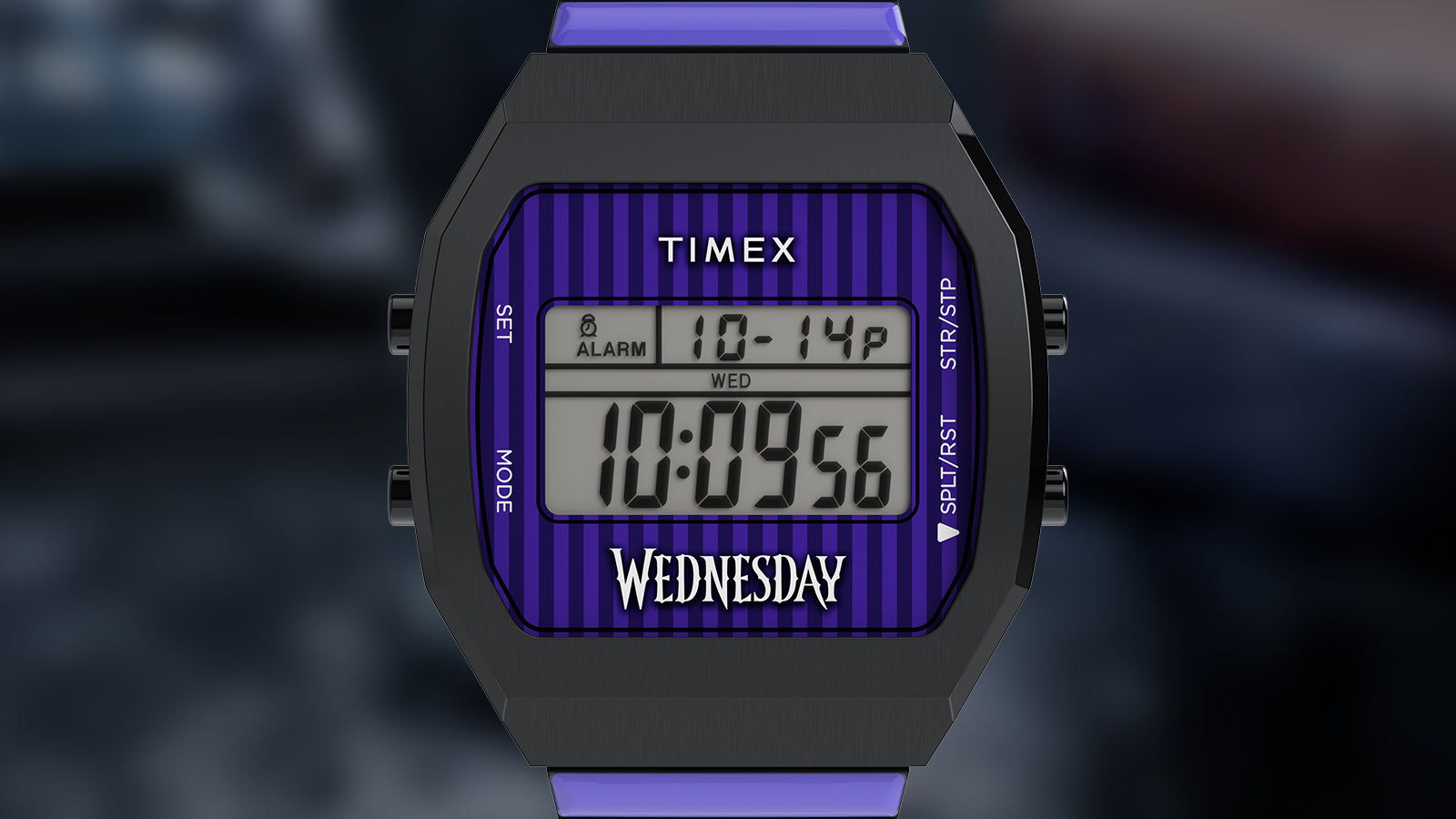 Front view of the Timex x Wednesday T80 showing the digital screen with purple and black striped border. The watch face displays the day, date, and time, with “Wednesday” styled in gothic font, paying homage to the Wednesday Addams series.