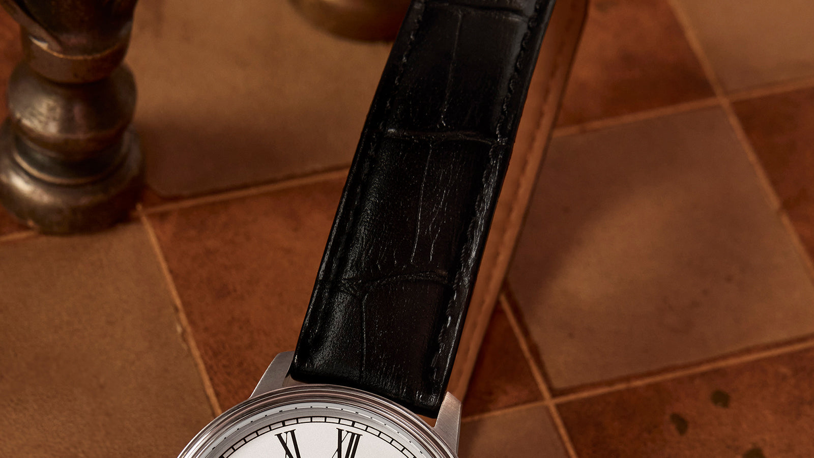 Close-up of the Timex Waterbury Metropolitan Sub-Second black leather strap with crocodile grain texture and fine stitching.