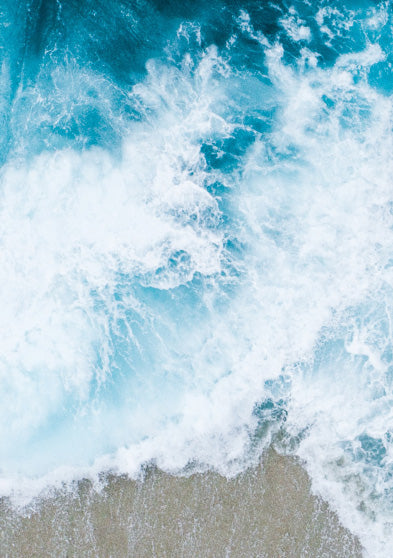 Aerial view of ocean waves crashing against the shore, symbolizing the marine inspiration behind the TIMEX® Legacy Ocean #tide watch.