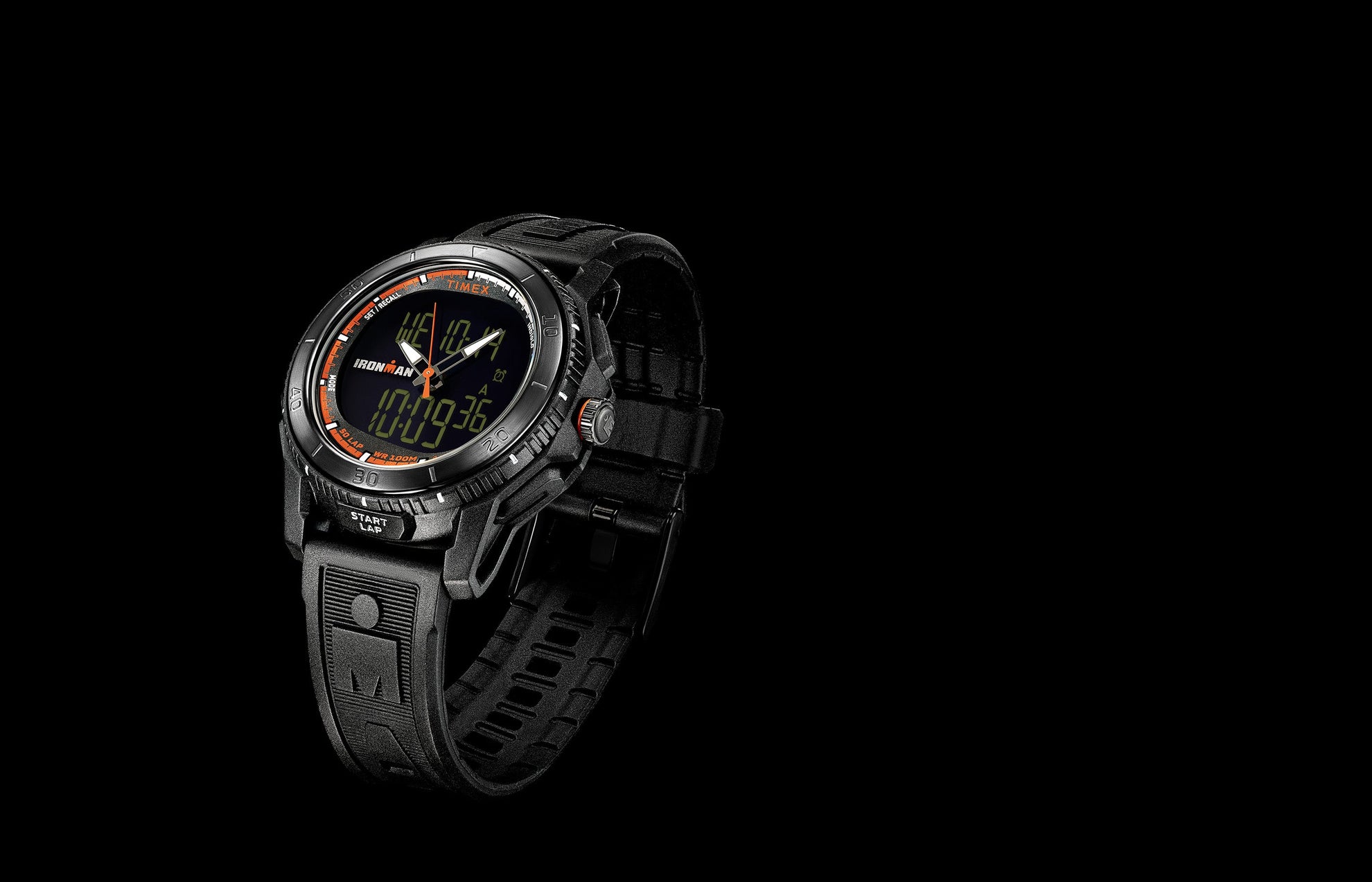 TIMEX® IRONMAN® Adrenaline Ana-Digi watch with black resin case, orange accents, and dual analog-digital display shown against a solid black background.