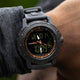 TIMEX® IRONMAN® Adrenaline Ana-Digi watch worn on wrist, displaying digital time and analog hands with orange detailing.