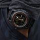 Close-up of the TIMEX® IRONMAN® Adrenaline Ana-Digi watch worn on the wrist, highlighting its rugged black case, luminous hands, and bright orange markings.